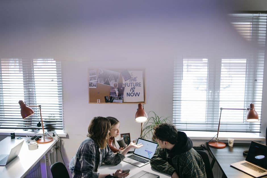 A small team collaborating in a sunny office